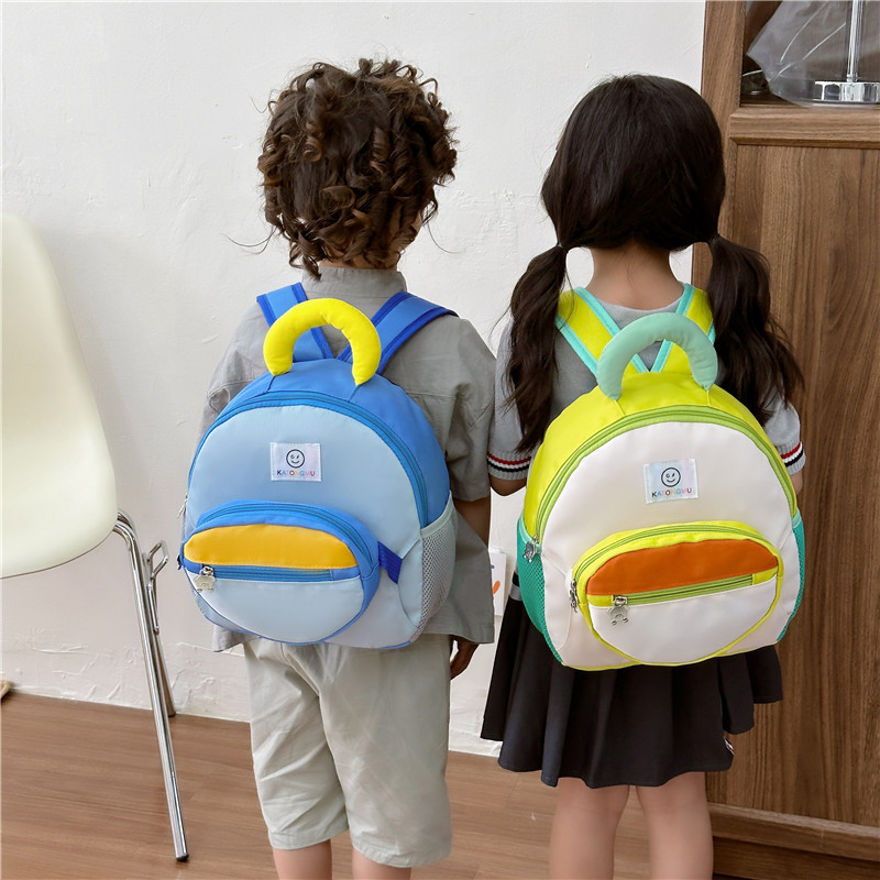 Kids backpack, two children wearing small colour block school backpacks with front zip pockets
